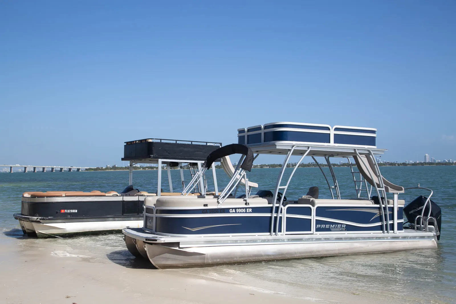Two double-deck tritoons at the beach