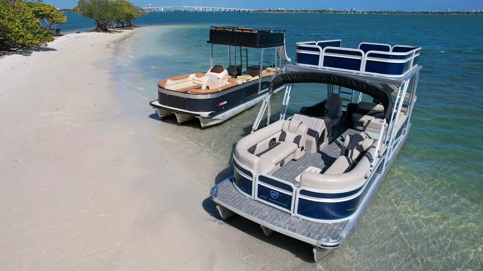 Tritoons anchored at a sandy island near Miami